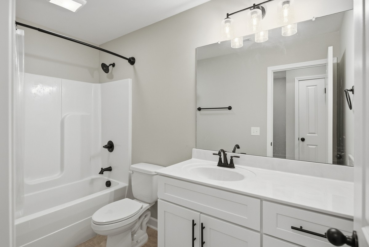 1279 Bluebird Road Lebanon, TN 37087 - Photo 26 of 33 a bathroom with a sink a toilet and a mirror