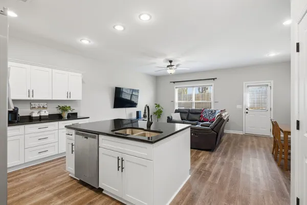 a kitchen with sink stove and cabinets