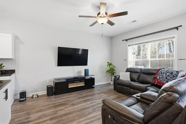a living room with furniture and a flat screen tv