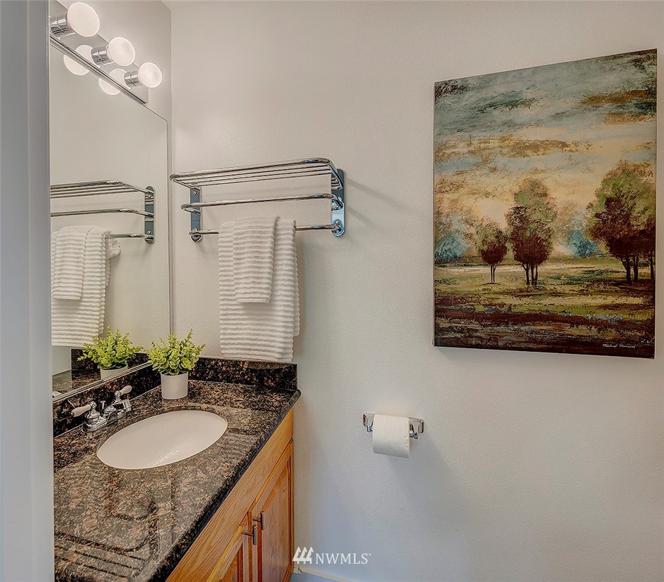 1809 Holbrook Avenue Everett, WA 98203 - Photo 17 of 40 a bathroom with a granite countertop sink a mirror and shower