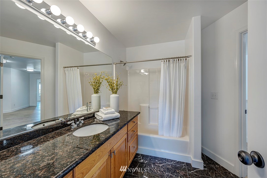 1809 Holbrook Avenue Everett, WA 98203 - Photo 29 of 40 a bathroom with a granite countertop sink and a mirror