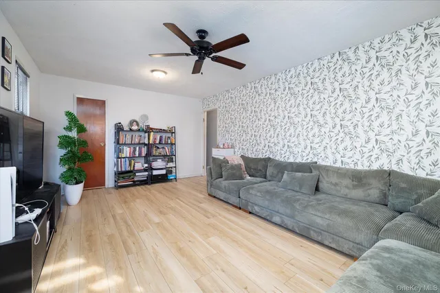 a living room with a couch and a book shelf