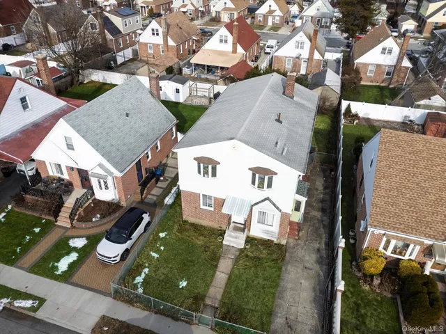 an aerial view of residential houses with outdoor space