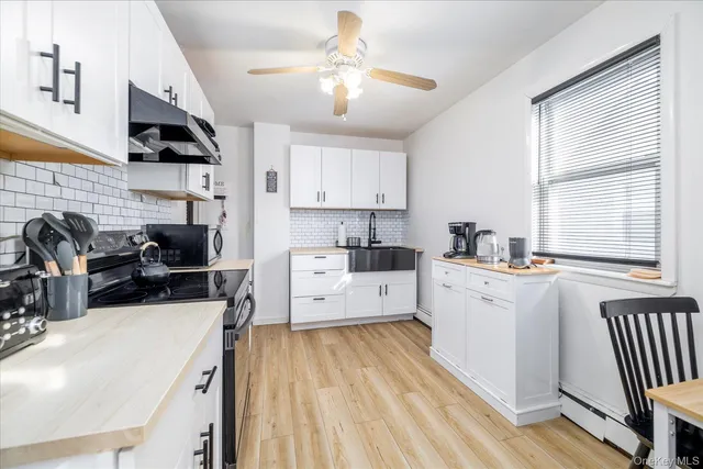 a kitchen that has a lot of cabinets a sink and a stove