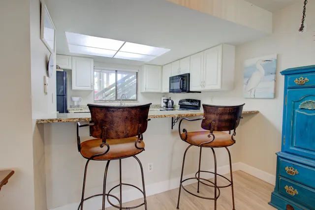 a bathroom with a granite countertop sink a toilet and a mirror
