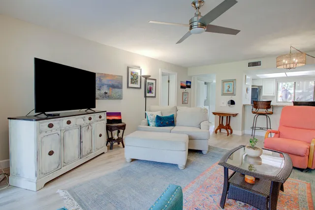 a living room with furniture and a floor to ceiling window