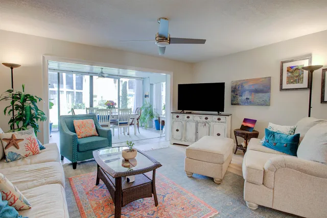 a dining room with furniture potted plants and wooden floor