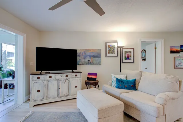 a living room with furniture and a floor to ceiling window