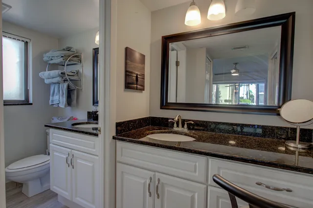 a bedroom with a bed and a flat tv screen next to a window