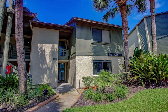 a kitchen with granite countertop a refrigerator and a stove top oven