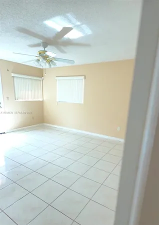 a view of an empty room and a window