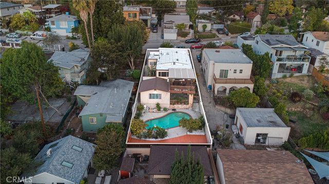 an aerial view of multiple houses with yard