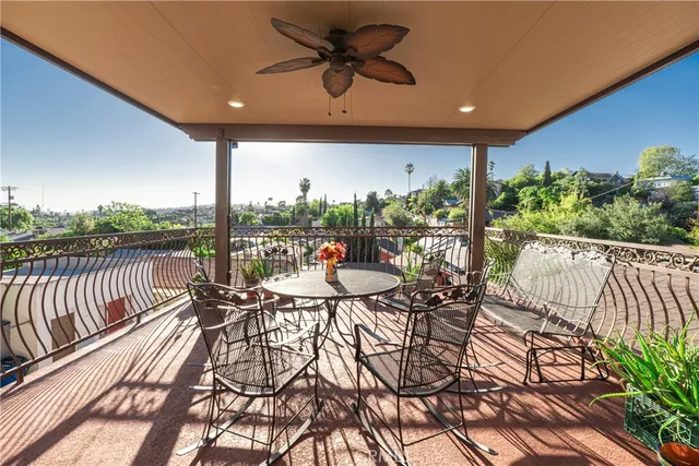 a view of a chairs and table in the balcony