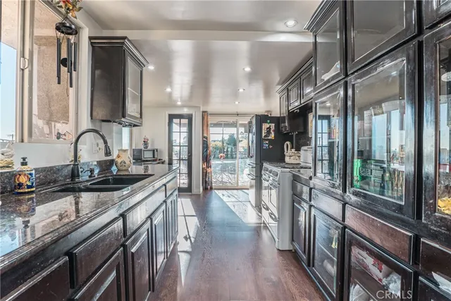 a kitchen with stainless steel appliances a sink and a stove top oven