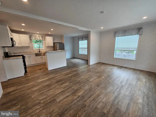 a view of kitchen with cabinets and wooden floor