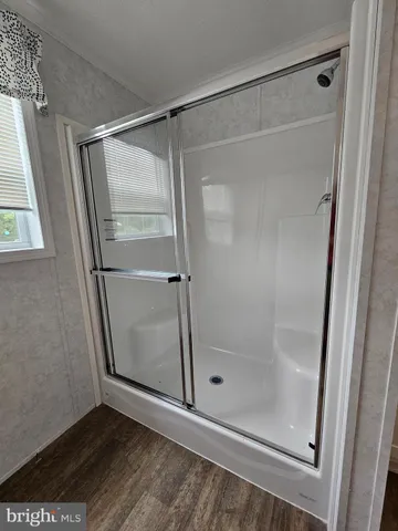 a bathroom with a glass shower door
