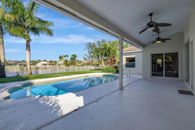 an aerial view of residential houses with outdoor space and parking