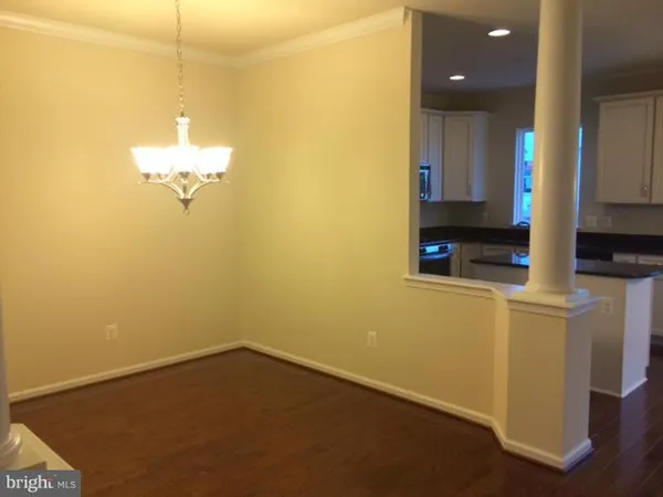 a kitchen with stainless steel appliances granite countertop cabinets and wooden floor
