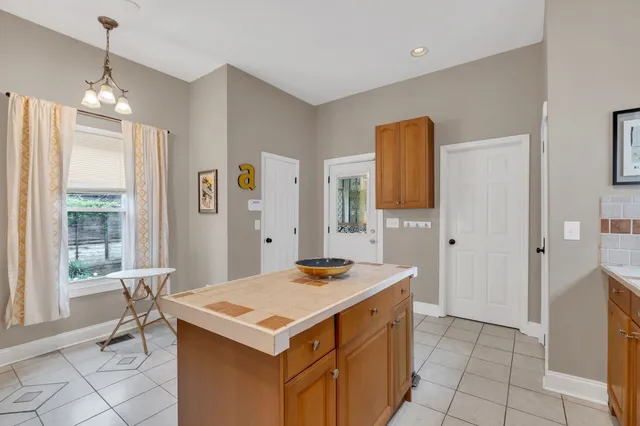 a kitchen that has a sink a table and chair in it