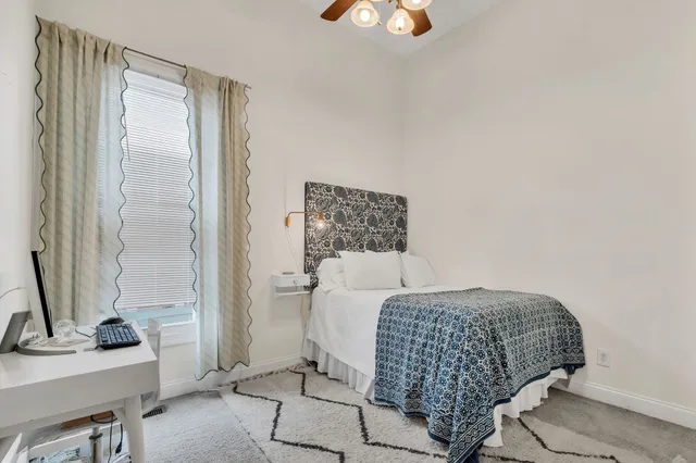 a bedroom with a bed and a mirror