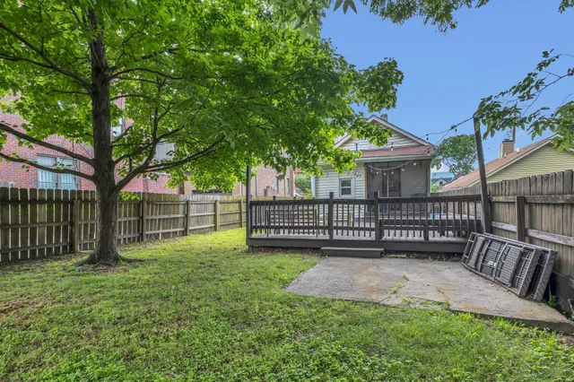 a view of a yard with a deck and a yard