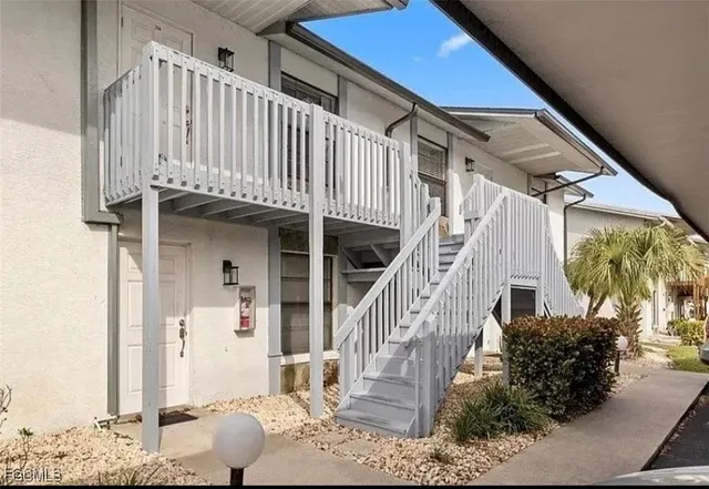 a large kitchen with a large window a counter space stainless steel appliances and cabinets