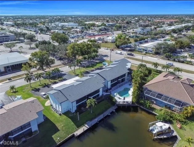 an aerial view of a house with swimming pool garden and mountain view