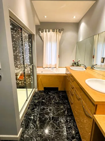 a bathroom with a granite countertop sink and a large mirror
