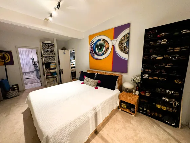 a bed room with a bed and a television