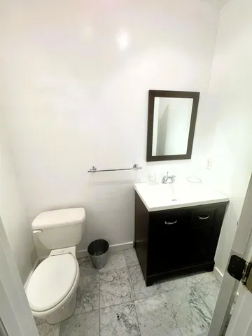 a bathroom with a sink toilet and mirror
