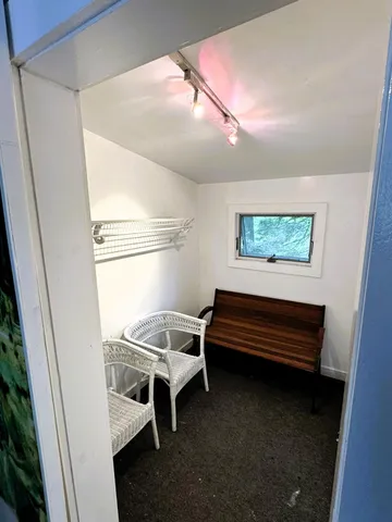 a view of bedroom with furniture and a window