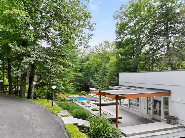 a view of a chairs and table in the backyard