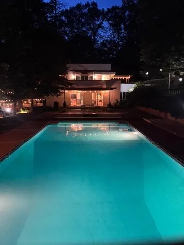 a view of a swimming pool with an outdoor seating and deck