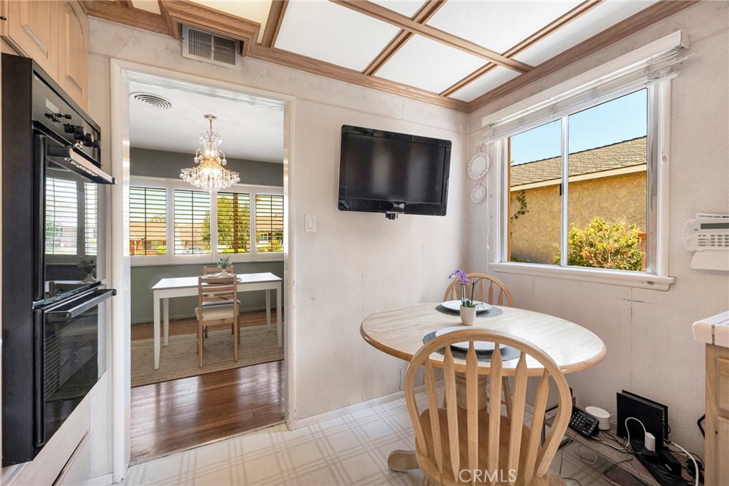 630 Uclan Drive Burbank, CA 91504 - Photo 11 of 41 a dining room with furniture and a flat screen tv