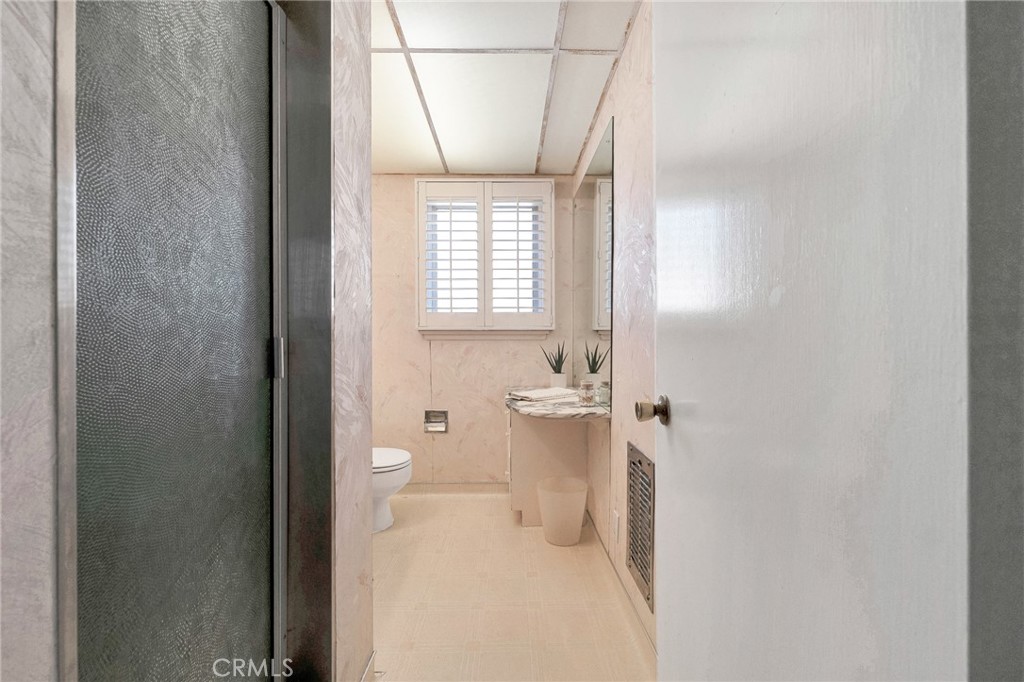 630 Uclan Drive Burbank, CA 91504 - Photo 16 of 41 a bathroom with a granite countertop sink and a toilet