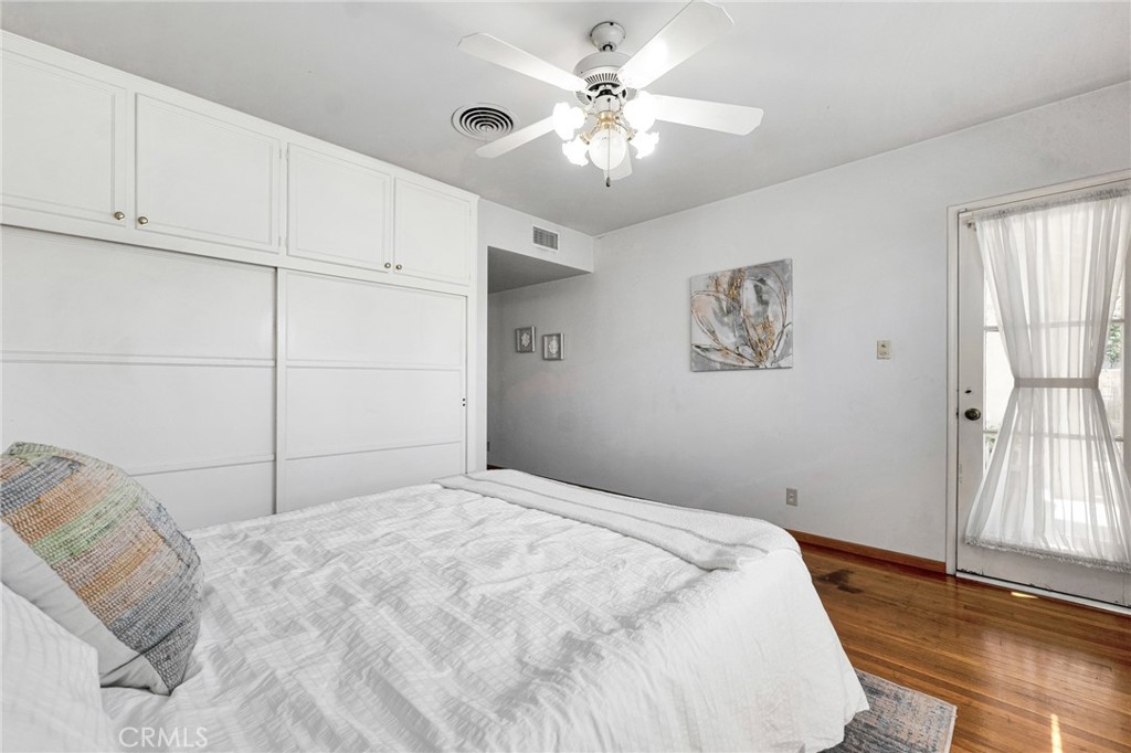 630 Uclan Drive Burbank, CA 91504 - Photo 21 of 41 a bedroom with a large bed and a chandelier