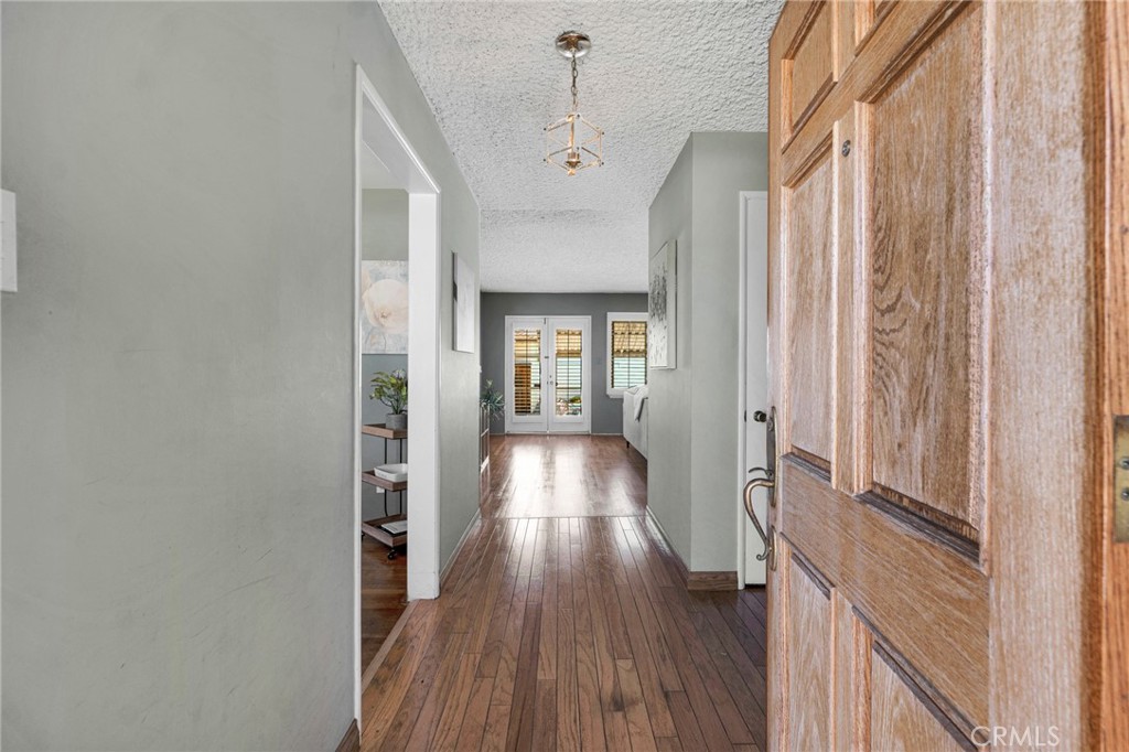 630 Uclan Drive Burbank, CA 91504 - Photo 33 of 41 a view of a hallway with wooden floor and staircase