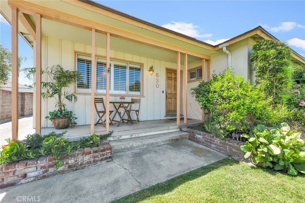 630 Uclan Drive Burbank, CA 91504 - Photo 41 of 41 front view of a house with potted plants and a bench