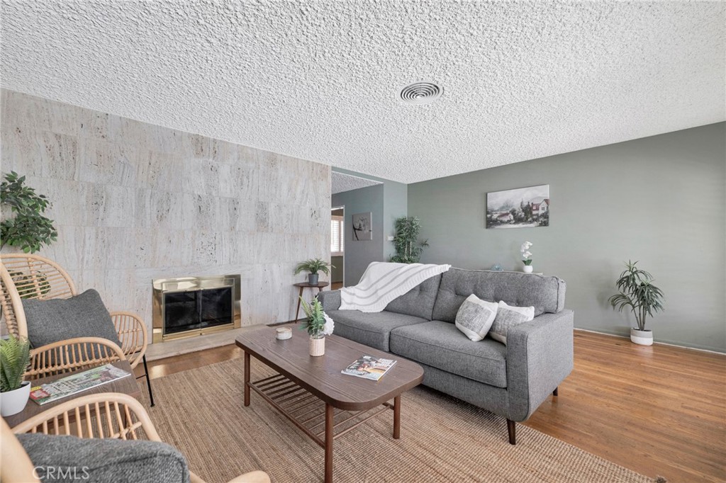 630 Uclan Drive Burbank, CA 91504 - Photo 5 of 41 a living room with furniture and a fireplace