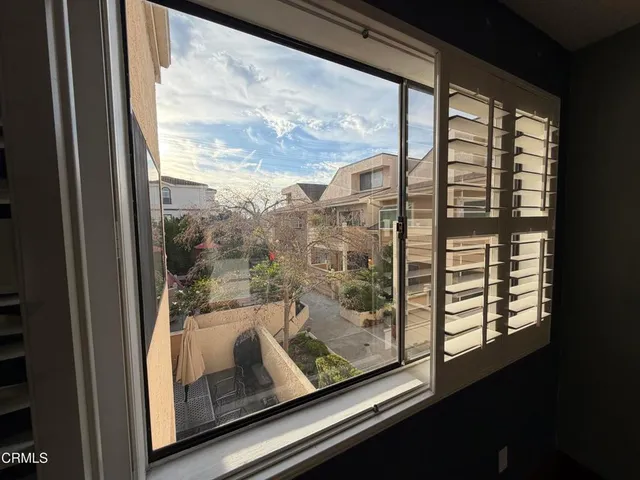 a view of a glass door with a tree