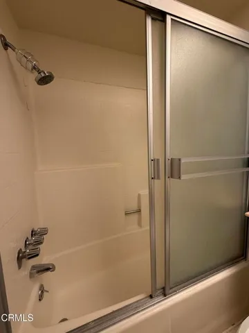 a bathroom with a shower and a shower