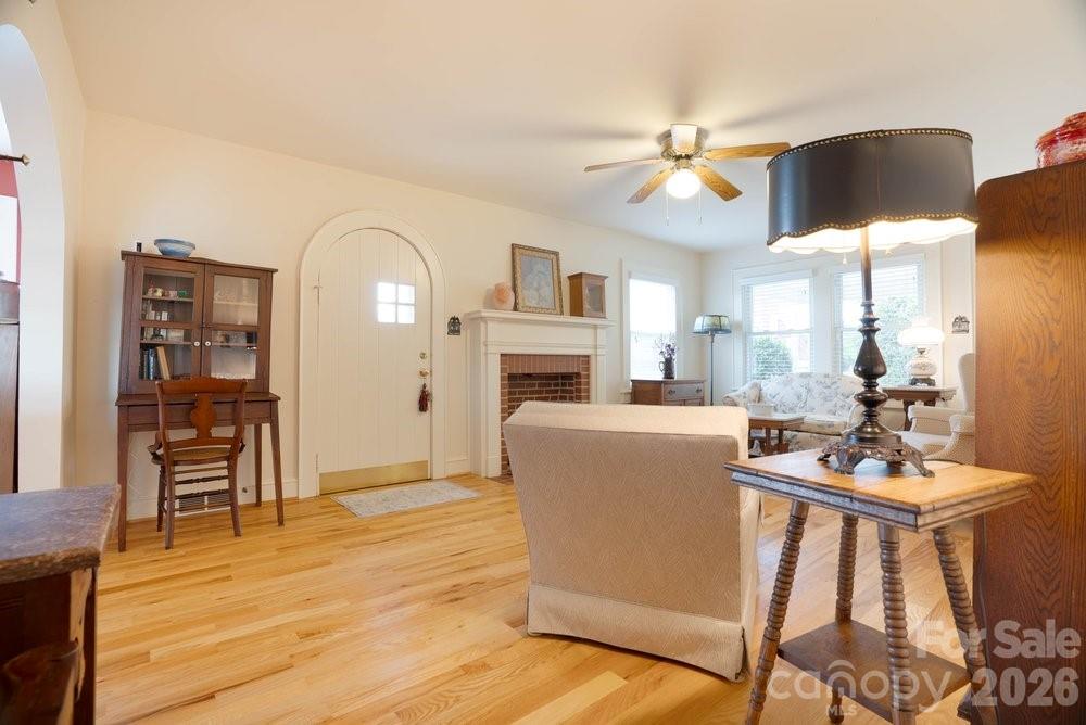 124 Rumple Street Troutman, NC 28166 - Photo 12 of 42 a living room with furniture a fireplace and a flat screen tv