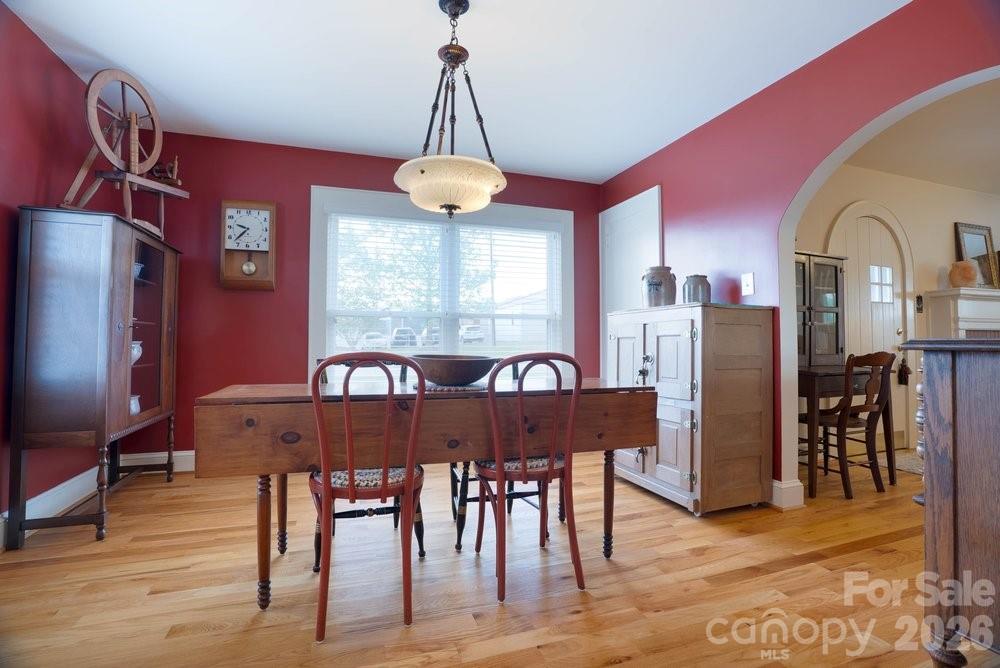 124 Rumple Street Troutman, NC 28166 - Photo 14 of 42 a view of a dining room with furniture window and wooden floor