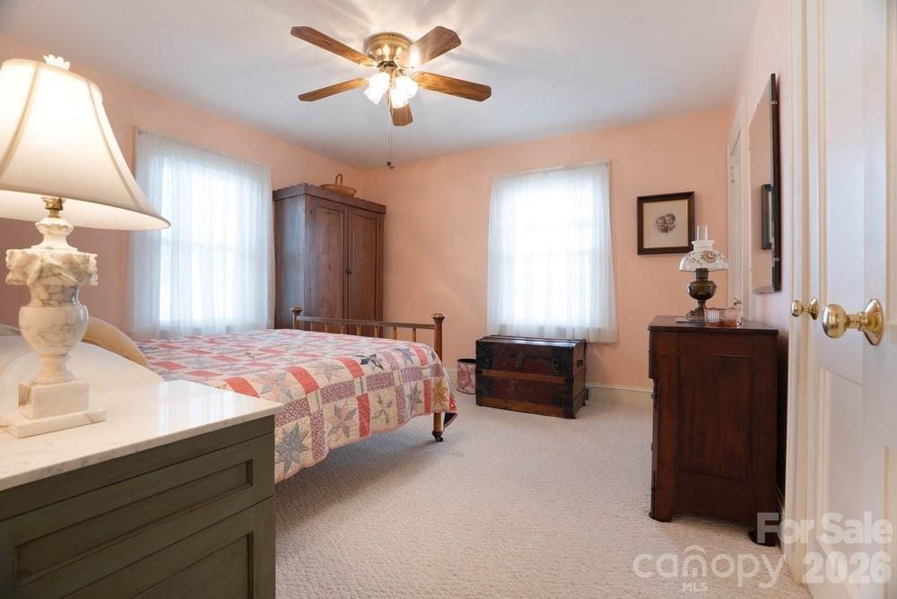 124 Rumple Street Troutman, NC 28166 - Photo 20 of 42 a bedroom with a bed and a chandelier