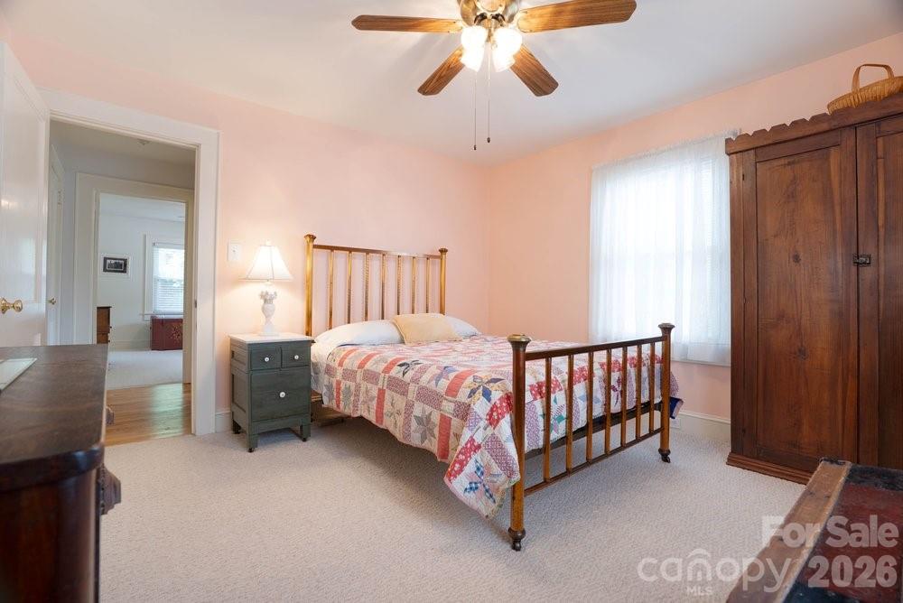 124 Rumple Street Troutman, NC 28166 - Photo 21 of 42 a bed room with a bed and a chandelier