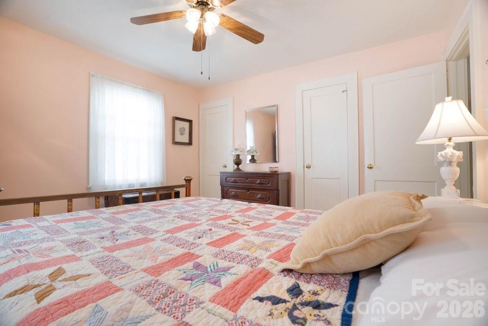124 Rumple Street Troutman, NC 28166 - Photo 22 of 42 a bedroom with a bed and a chandelier
