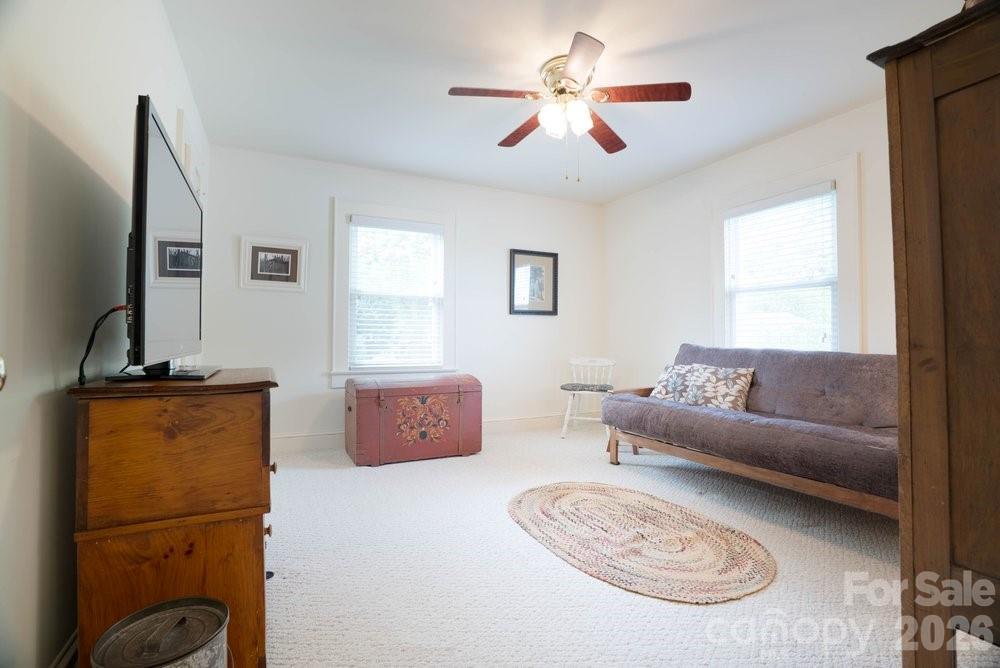 124 Rumple Street Troutman, NC 28166 - Photo 23 of 42 a living room with furniture a ceiling fan and a window