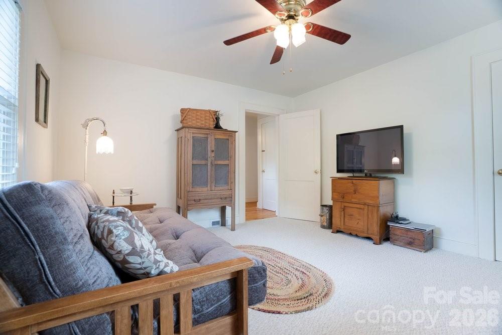 124 Rumple Street Troutman, NC 28166 - Photo 24 of 42 a living room with furniture and a flat screen tv