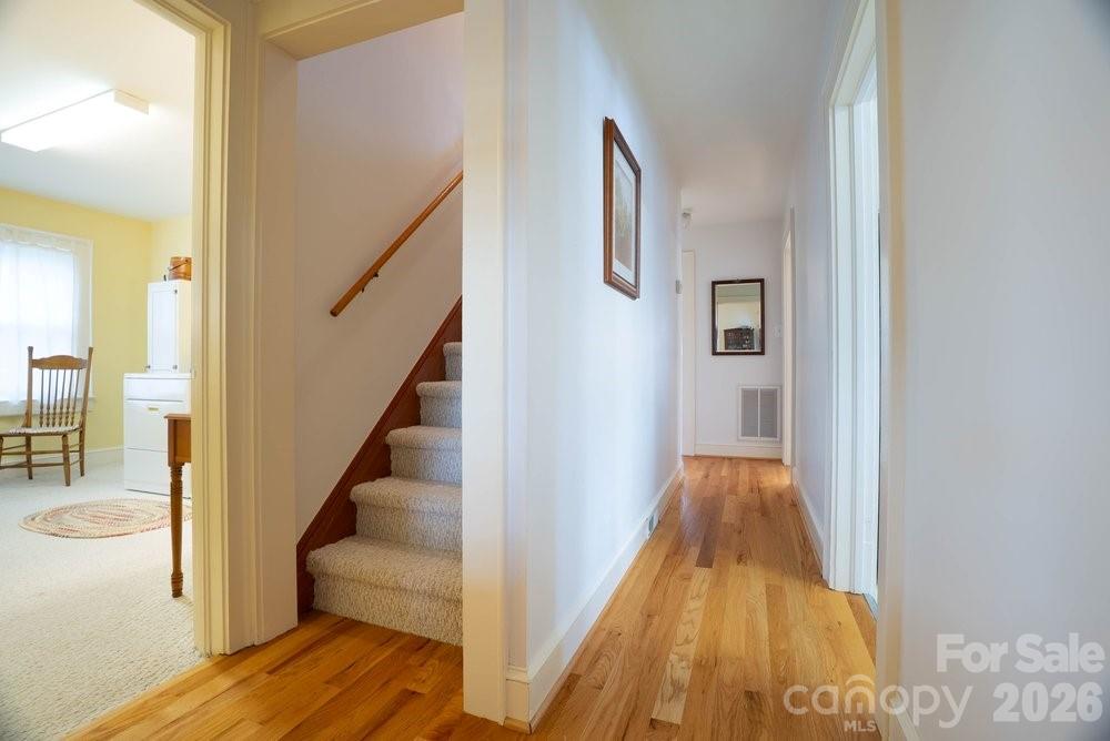 124 Rumple Street Troutman, NC 28166 - Photo 26 of 42 a view of a hallway with wooden floor and staircase
