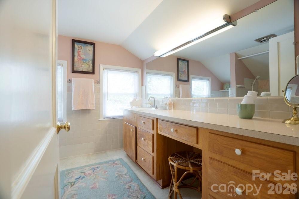 124 Rumple Street Troutman, NC 28166 - Photo 34 of 42 a spacious bathroom with a sink a mirror and a bathtub
